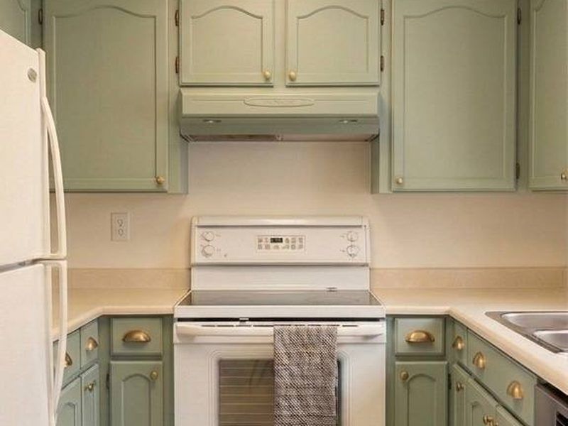 Kitchen cabinets after painting — sage green finish