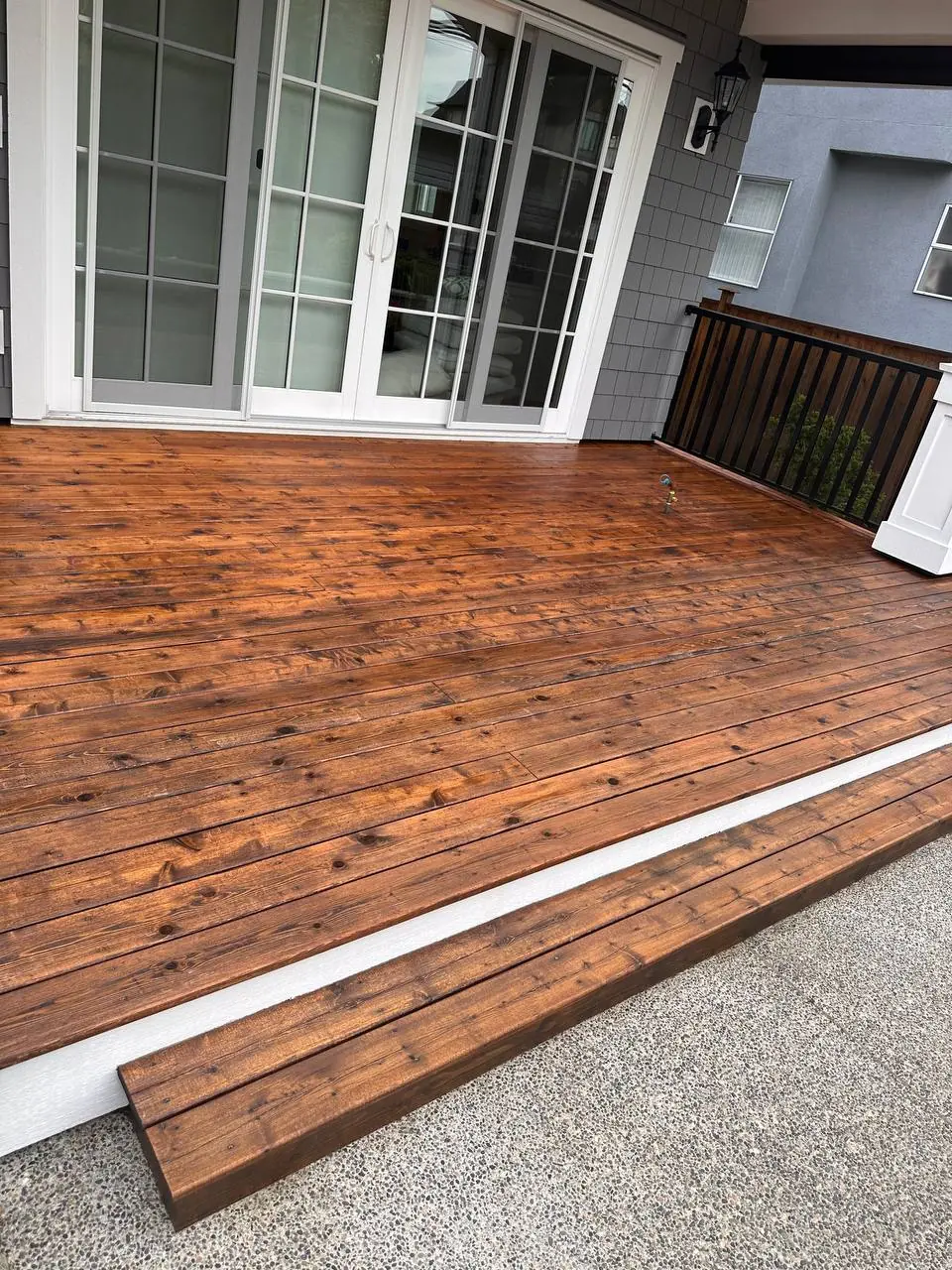 Tsawwassen deck after staining — rich warm brown finish, grain enhanced